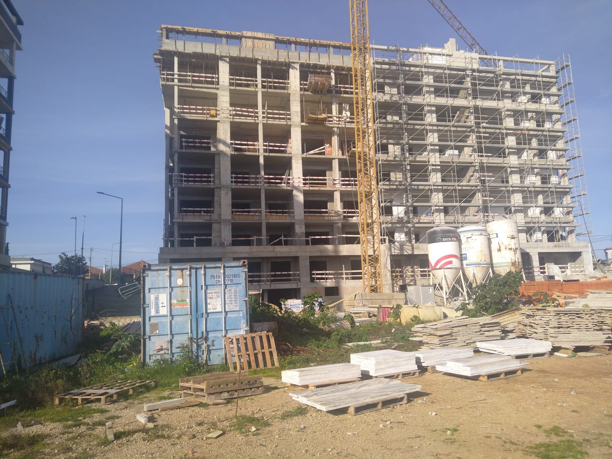 Concrete structure of the building with a tower crane and scaffolding